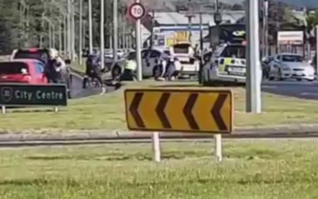 A screenshot from a video posted to Facebook, showing police gathered at the scene of the shooting in Rotorua.