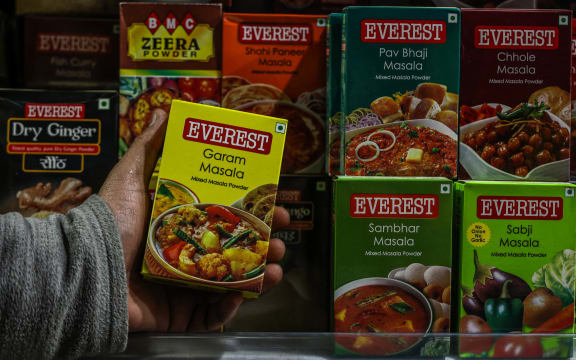 A shopkeeper is holding packets of MDH and Everest Spices at a department store in Baramulla, Jammu and Kashmir, India, on April 23, 2024. Hong Kong is banning the sale of popular Indian spice brands MDH Pvt. and Everest Food Products Pvt. following the alleged detection of the carcinogenic pesticide ethylene oxide in several spice mixes. (Photo by Nasir Kachroo/NurPhoto) (Photo by Nasir Kachroo / NurPhoto / NurPhoto via AFP)