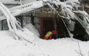 A rescuer at the Hotel Rigopiano.
