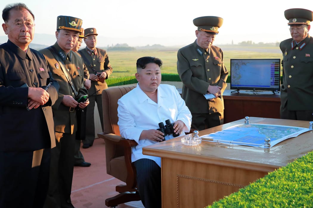 This undated picture released from North Korea's official Korean Central News Agency shows North Korean leader Kim Jong-Un (C) inspecting the test of a new anti-aircraft guided weapon system organized by the Academy of National Defence Science at an undisclosed location.