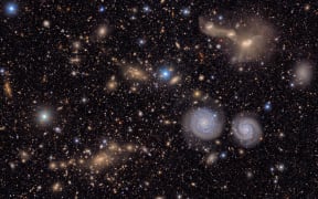 This image shows a small section of NSF-DOE Vera C. Rubin Observatory's total view of the Virgo cluster of galaxies, including two spiral galaxies (lower right) and three merging galaxies (upper right).
Mandatory Credit:	NSF-DOE Vera C. Rubin Observatory via CNN Newsource