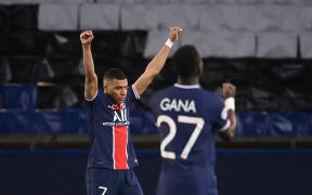 Paris Saint-Germain forward Kylian Mbappe and midfielder Idrissa Gueye celebrate after winning the Champions League quarter-final tie against FC Bayern Munich at the Parc des Princes stadium in Paris, on April 13, 2021.