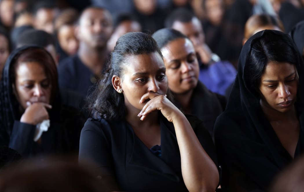 Colleagues mourn during a memorial ceremony held for the crew who died in the Ethiopian Airlines crash in Addis Ababa, Ethiopia.
