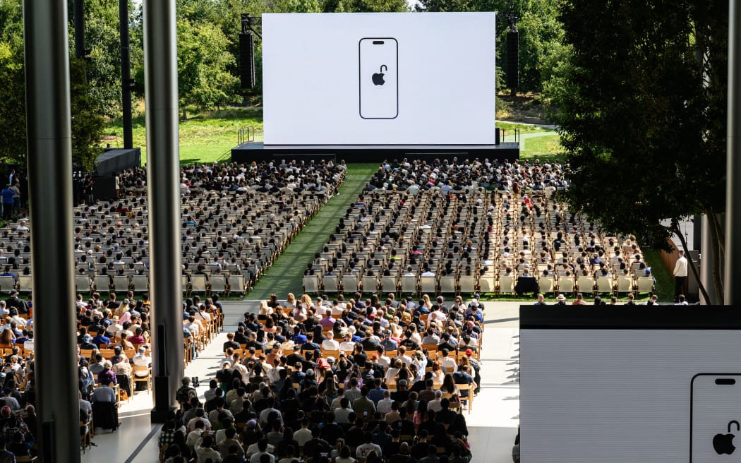 Attendees watch a presentation during the annual Apple "Worldwide Developers Conference" (WWDC) at Apple Park, the corporate headquarters of Apple Inc., in Cupertino, California on June 9, 2025. Pressure is on Apple to show it hasn't lost its magic despite broken promises to ramp up iPhones with generative artificial intelligence (GenAI) as rivals race ahead with the technology. Apple will showcase plans for its coveted devices and the software powering them at its annual Worldwide Developers Conference (WWDC) kicking off Monday in Silicon Valley and running through June 13. (Photo by Josh Edelson / AFP)