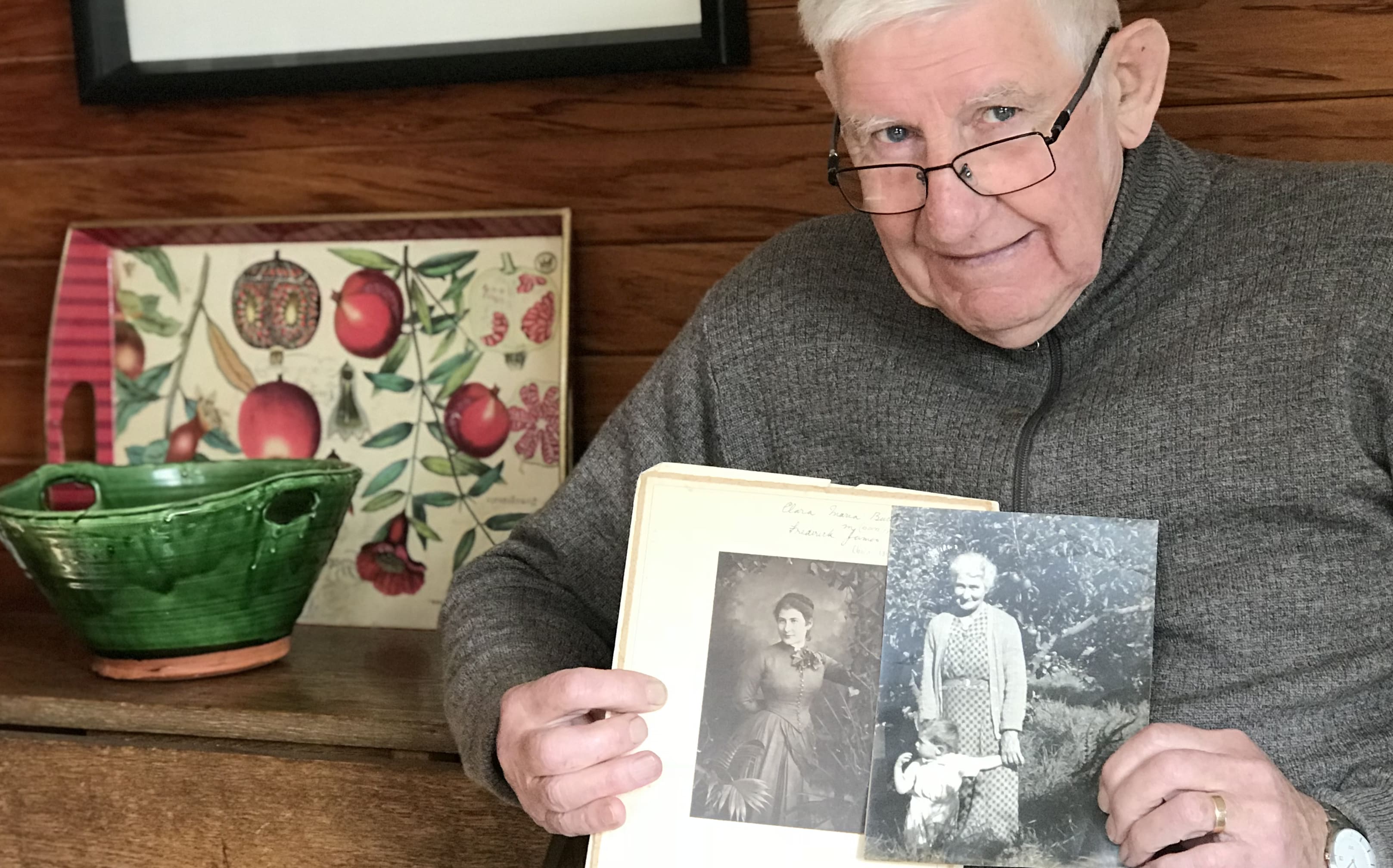 Rod Alley with photographs of his grandmother Clara Alley