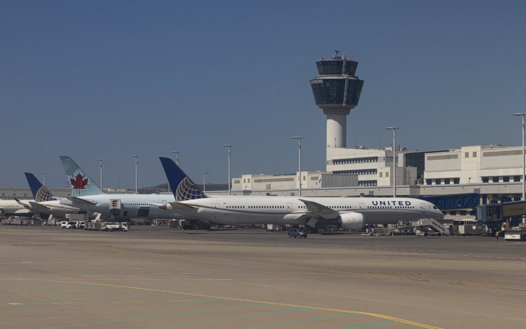 United Airlines Boeing 787-10 Dreamliner passenger plane in front of the terminal and the gates of Athens International Airport ATH in Greece.