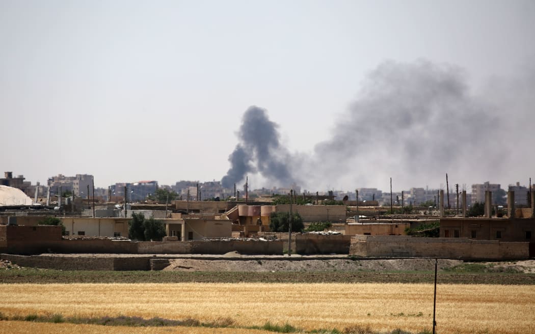 Smoke rises from buildings in the al-Meshleb neighbourhood of Raqqa as the Syrian Democratic Forces advance on 7 June.