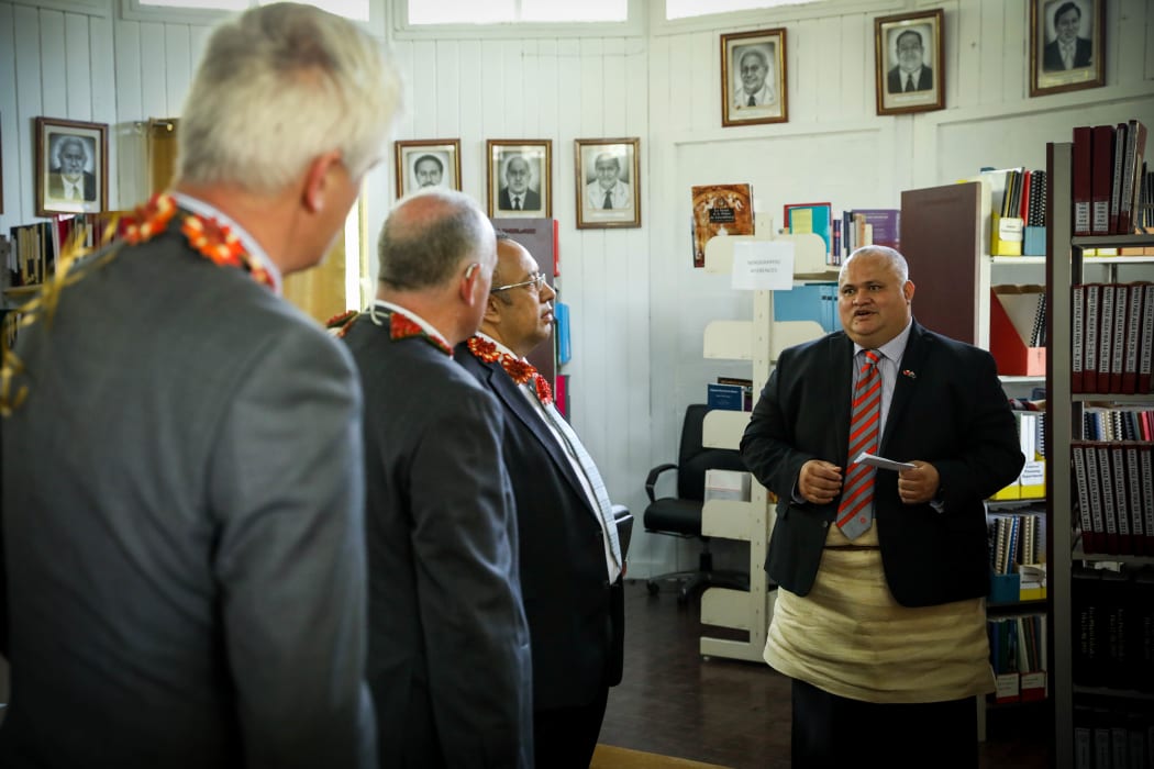 Deputy Clerk of Tonga's Parliament Sione Vikilani shows the New Zealand group the temporary parliamentary library.
