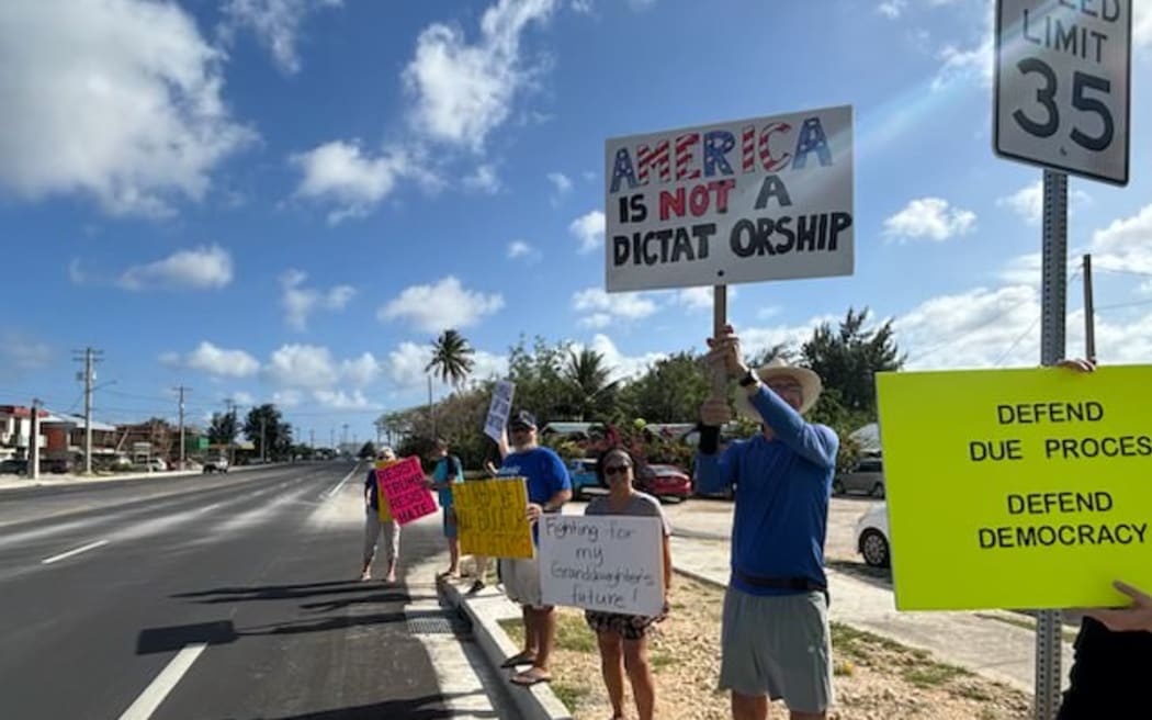 The anti-Trump protest took place in front of Oleai Beach Bar and Grill in San Jose, Saipan.