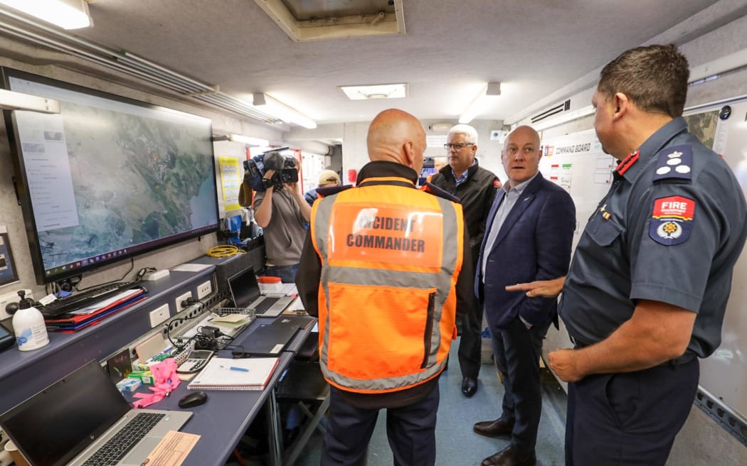 Prime Minister Christopher Luxon meets with emergency services and locals in Port Hills, Christchurch, on 22 February, 2024, after a fire burned through 650ha of land.