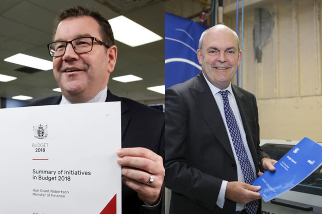 Who held it better? Finance Minister Grant Robertson with Budget 2018 (right) and former Finance Minister Steven Joyce with Budget 2017 (left).