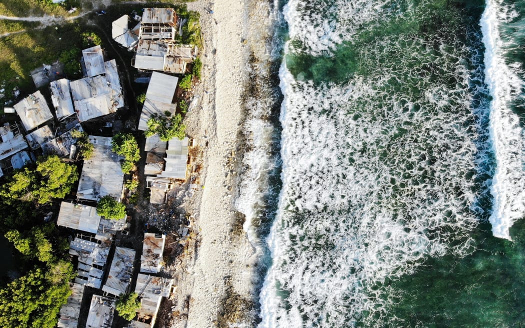 Coastal homes in Tuvalu, Funafuti pictured on November 28, 2019. The low-lying South Pacific island nation of about 11,000 people has been classified as "extremely vulnerable" to climate change by the United Nations Development Programme due to rising sea levels.