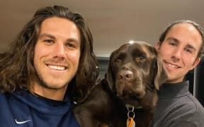 Callum, left, and Jake Robinson with their family dog.