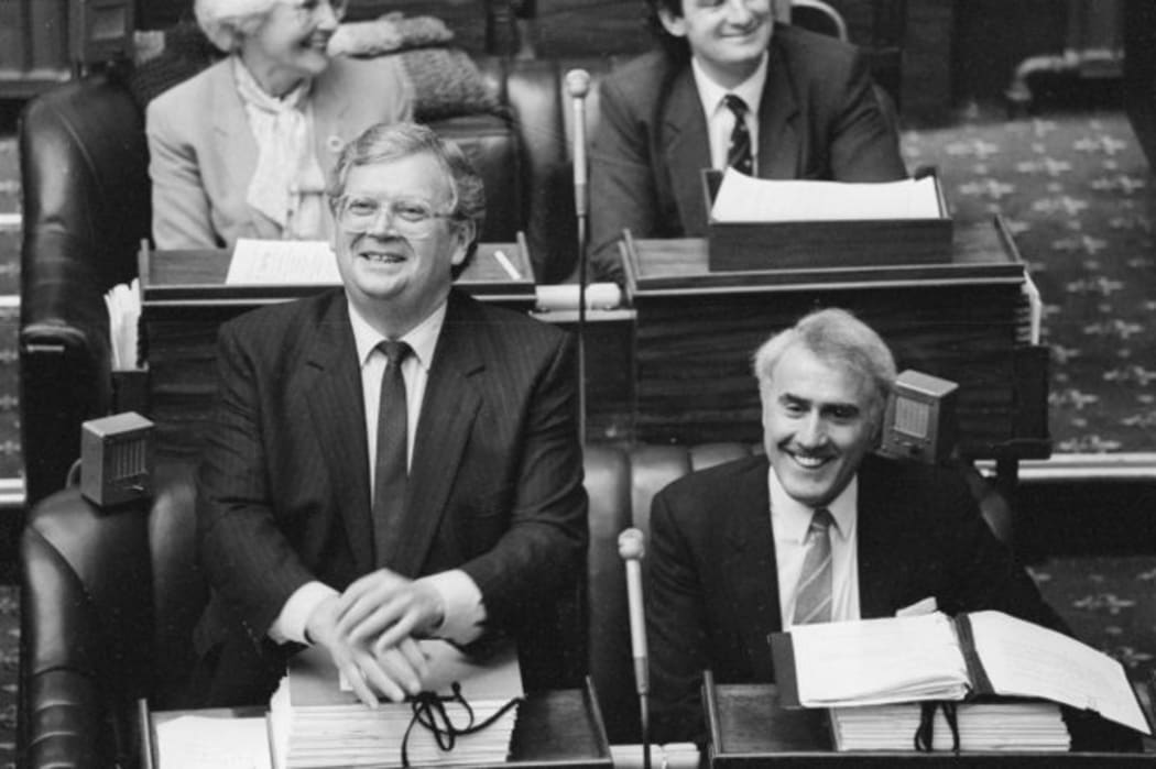 The day David Lange (left) steps down as Prime Minister. His successor Geoffrey Palmer (right) sits beside him, 1989.