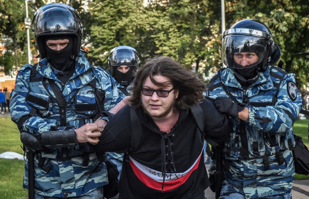 Servicemen of the Russian National Guard detain a man following a rally calling for fair elections in central Moscow on August 10, 2019.