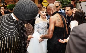 This picture by The Straits Times taken on 13 November 2025 and provided on 14 November shows stars Ariana Grande (C) and Cynthia Erivo (2nd R) at the premiere of their film "Wicked: For Good" in Singapore.