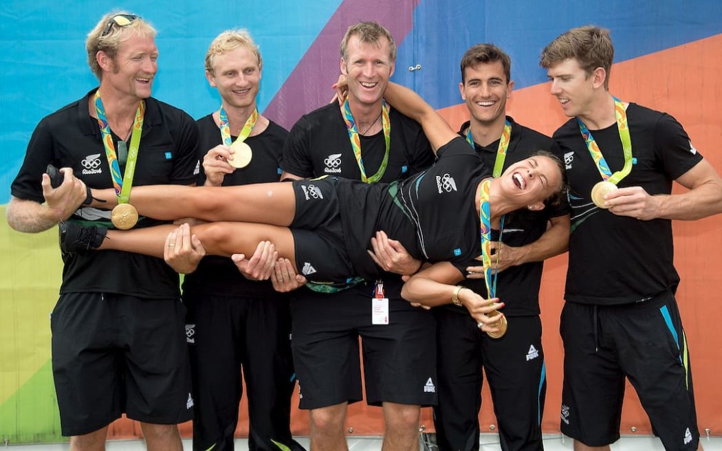 New Zealand Olympic gold medal winners Eric Murray, Hamish Bond, Mahe Drysdale, Peter Burling, Blair Tuke and Lisa Carrington, outside the Athletes village at the 2016 Rio Olympics.