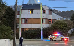 Armed police are still at the scene of a cordoned-off building on Webb Street in Wellington.