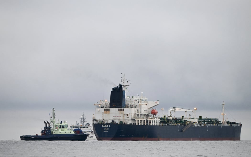 A photo taken on December 28, 2024 off Porkkalanniemi, Kirkkonummi, in the Gulf of Finland, shows oil tanker Eagle S (R), which flies under the flag of the Cook Islands, next to Finnish border guard ship Uisko (back C) and tugboat Ukko (front L). - Estonia has begun naval patrols to protect an undersea cable supplying electricity from Finland following suspected sabotage of another one on Christmas Day, Defence Minister Hanno Pevkur said December 27. In a separate statement, Pevkur said Tallinn wanted to send a clear message that it was ready to protect its power connections with Finland with both military and non-military means. The Estlink 2 submarine cable was disconnected from the grid on December 25, just over a month after two telecommunications cables were severed in Swedish territorial waters in the Baltic Sea. Finnish authorities said on December 26 that they were investigating an oil tanker that sailed from a Russian port over suspected "sabotage". The Eagle S vessel was en route to Port Said in...