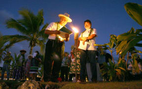 John Doom (L), the founder of the association for the victims of nuclear tests called "Mururoa e Tatou", reads the list of the 319 members who died since the creation of the association on 2 July 1966.