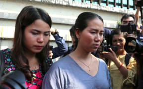 Chit Su Win (L) and Panei Mon (R) wife of jailed Myanmar journalists Kyaw Soe Oo and Wa Lone leave the high court in Yangon on January 11, 2019. AFP