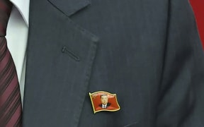 This photo provided Monday, July 1, 2024, by the North Korean government shows that a senior official wears lapel pins with the image of Kim Jong Un during a ruling party’s meeting in Pyongyang Sunday, June 30, 2024. Independent journalists were not given access to cover the event depicted in this image distributed by the North Korean government. The content of this image is as provided and cannot be independently verified. (Korean Central News Agency/Korea News Service via AP)