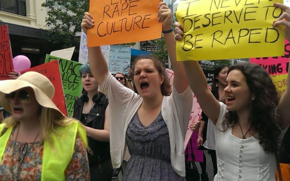 Michaela Housiaux-Andrews, 18, and Isobel Gledhill, 19, chant beneath their placards.