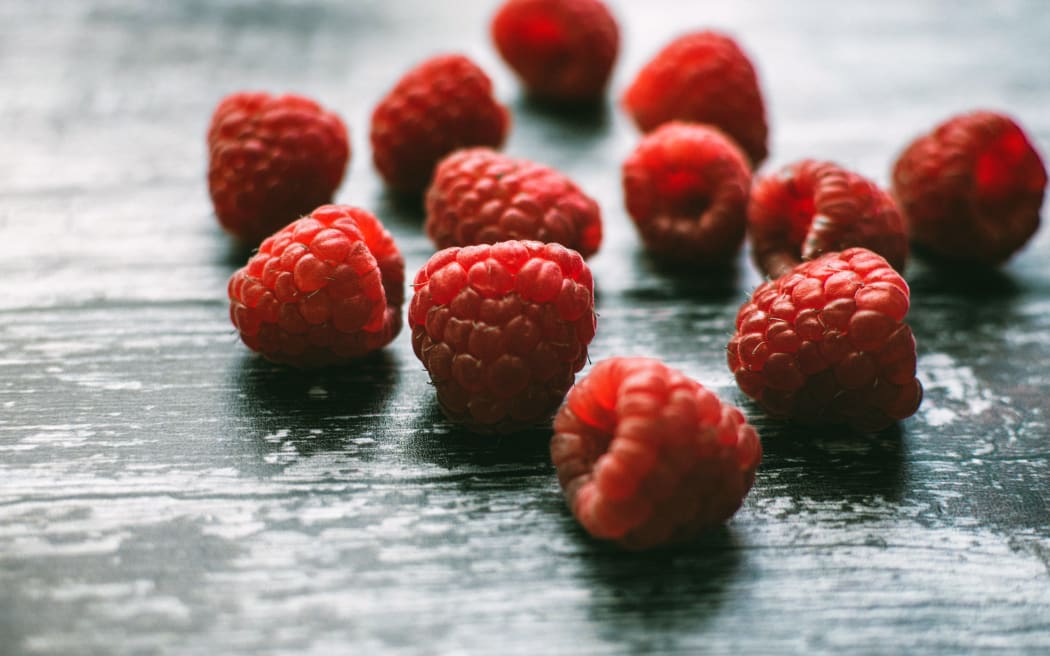 fresh raspberries on a bench