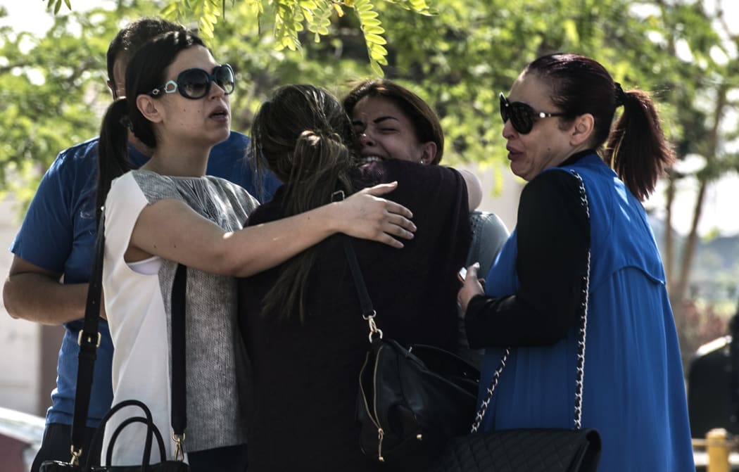 Families of passengers who were flying in an EgyptAir plane that vanished from radar en route from Paris to Cairo react as they wait outside a services hall at Cairo airport.