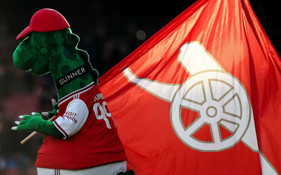 The Gunnersaurus carries an Arsenal flag.