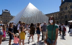 Visitors queuing to enter the Louvre Museum, Paris.