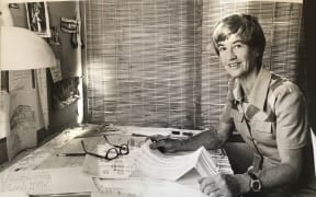 Lillian Chrystal sitting at her desk at 57 Symonds St