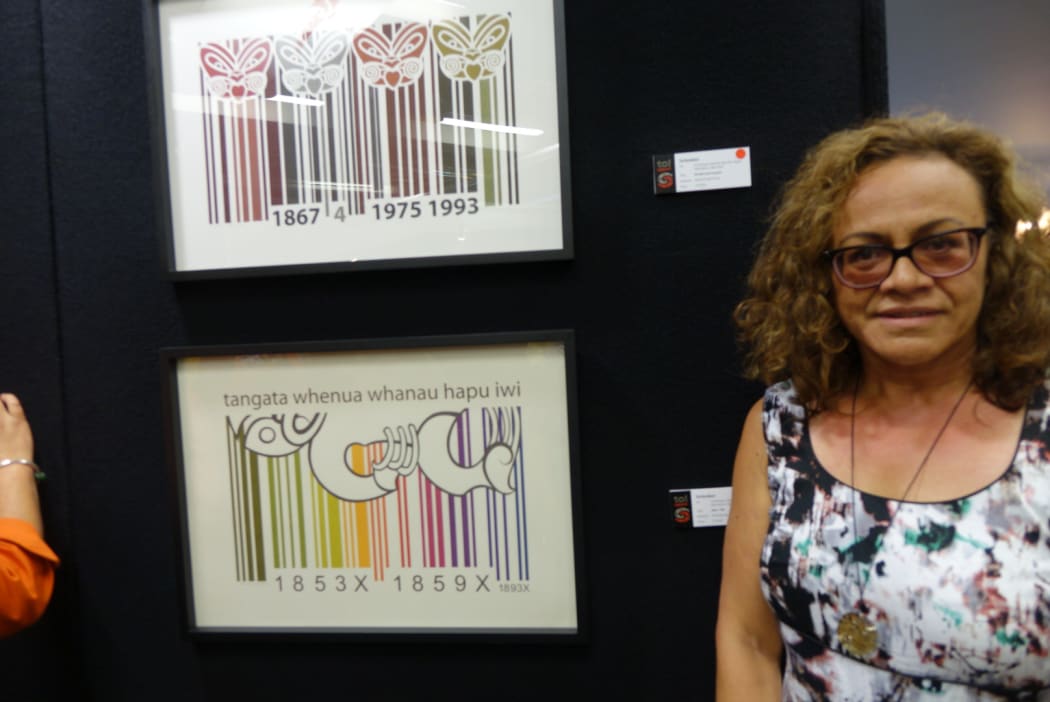 Professor Michelle Erai next to the print she bought this year.