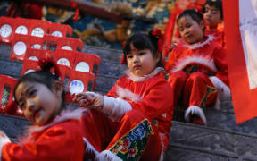 Children perform at the lantern festival, marking the last day of the Chinese new year, at Chinatown in Yokohama, Japan in  February 2019.