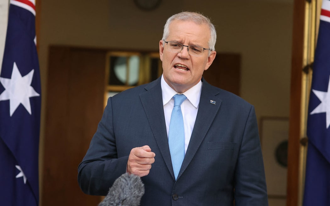 Australia's Prime Minister Scott Morrison attends a press conference at Parliament House in Canberra on April 10, 2022. - Australian Prime Minister Scott Morrison on April 10 called federal elections for May 21, launching a come-from-behind battle to stay in power after three years rocked by floods, bushfires and the Covid-19 pandemic. (Photo by AFP)