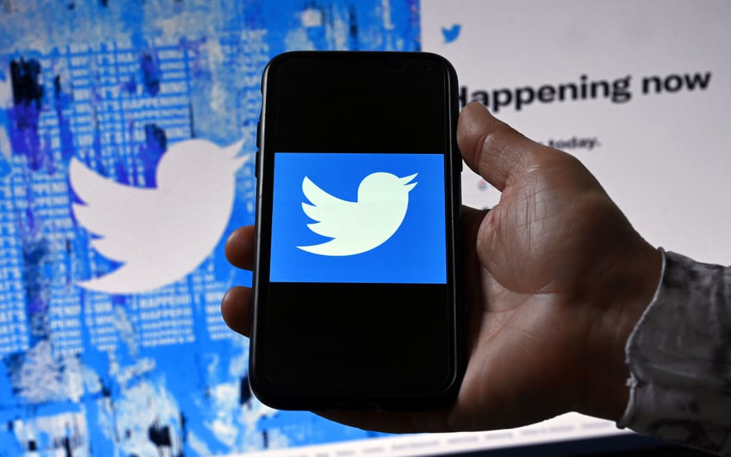 (FILES) In this file photo illustration taken on April 26, 2022, a phone screen displays the Twitter logo on a Twitter page background, in Washington, DC. - Twitter misled users and federal regulators about glaring weaknesses in its ability to protect personal data, the platform's former security chief claimed in whistleblower testimony likely to impact the company's bitter legal battle over Elon Musk's takeover bid. In a complaint filed with the US Securities and Exchange Commission and published in part August 23, 2022, by The Washington Post and CNN, Peiter Zatko also accused Twitter of significantly underestimating the number of automated bots on the platform -- a key element in Musk's argument for withdrawing his $44 billion buyout deal. (Photo by Olivier DOULIERY / AFP)