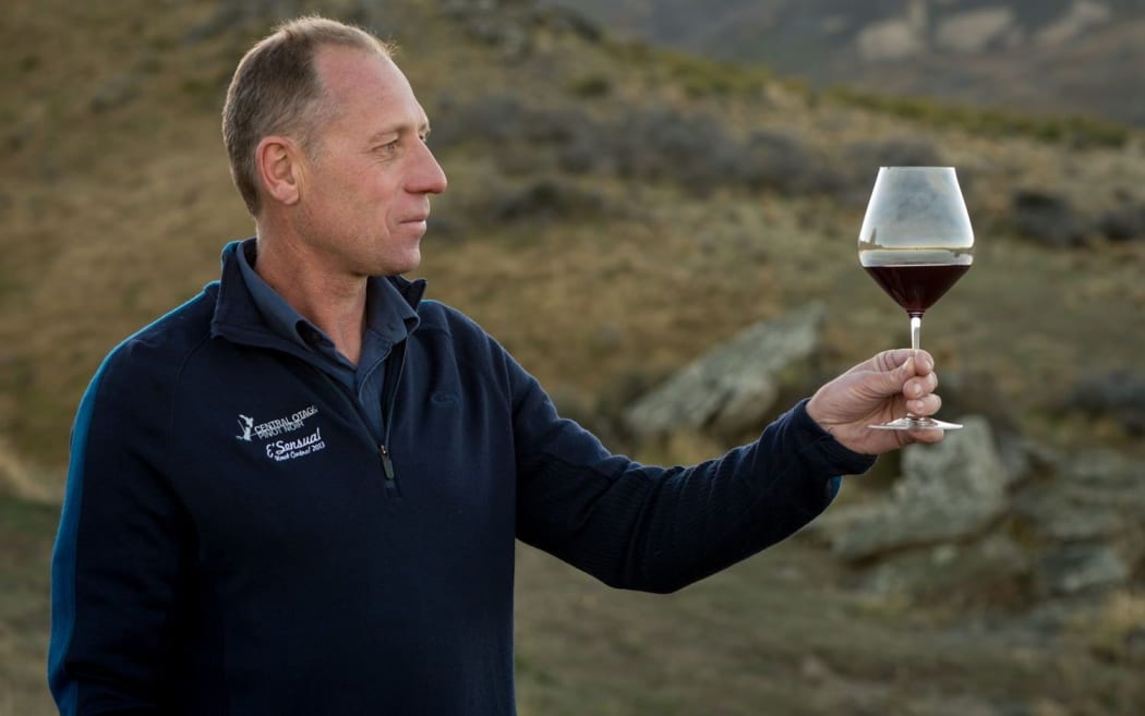 Central Otago Winegrowers Association spokesperson Rudi Bauer holding one of the new glasses.