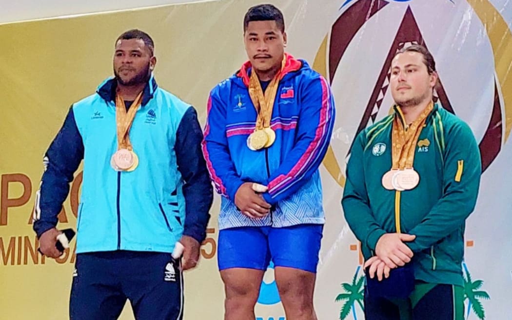 Jack Opeloge, middle, won two gold in the men's 110kg, taking the clean and jerk and the total, beating Fijian rival Taniela Rainibogi, left. Australia's Jackson Roberts-Young settled for the bronze medal.