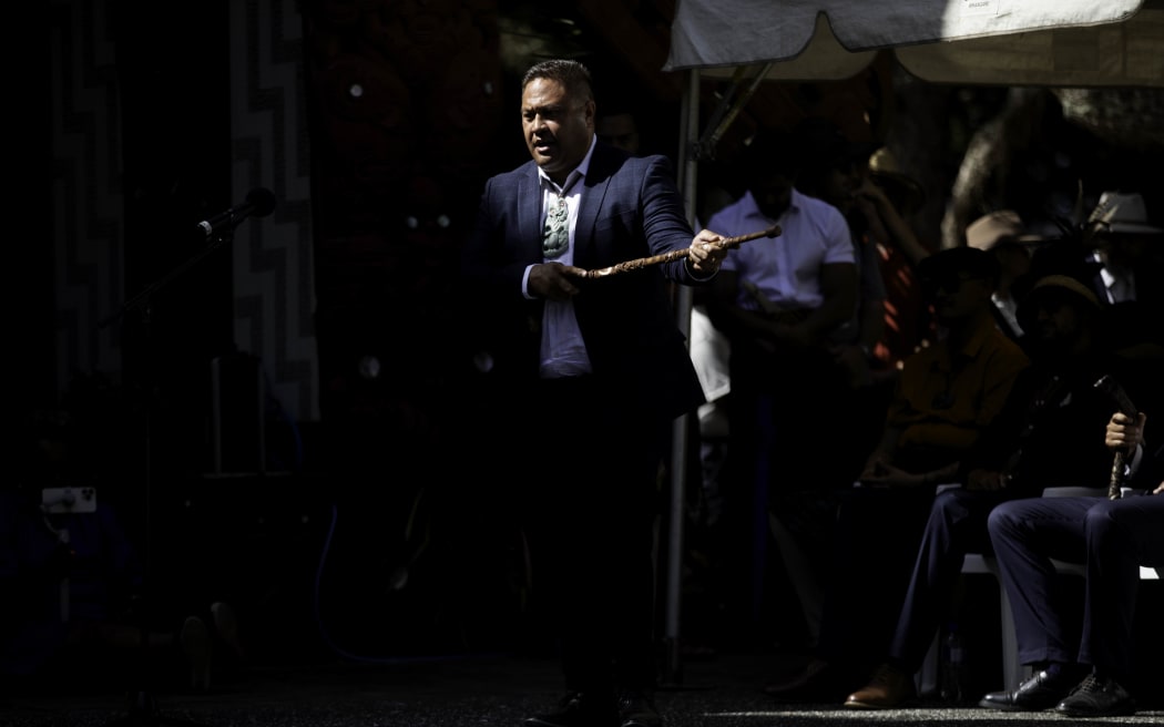 Rehua Mihaka - Ngāti Pikiao Te Arawa, speaks as a delegation including representatives from Kīngitanga, Rātana, Parihaka and Te Pāti Māori is welcomed on to Te Whare Rūnanga at the Treaty grounds, on 4 February, 2024.