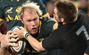 Schalk Burger of the Springboks tries to hand off Richie McCaw of the All Blacks.