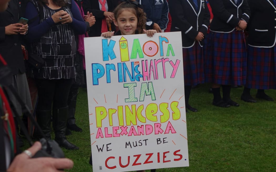 We girl with cuzzies sign for Prince Harry