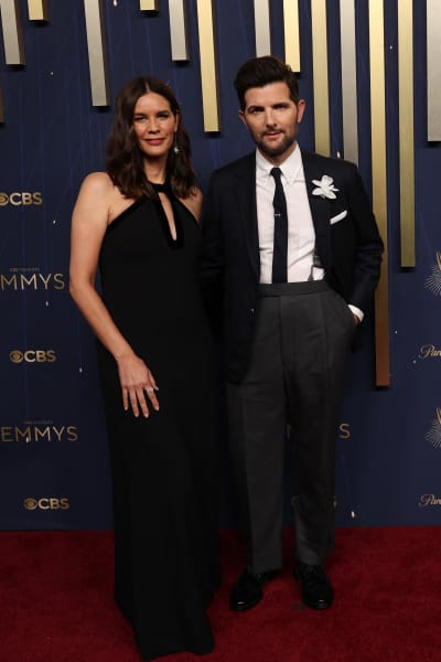 US actor Adam Scott (L) and spouse film producer Naomi Scott arrive for the 77th Primetime Emmy Awards at the Peacock Theatre at LA Live in Los Angeles on September 14, 2025. (Photo by Patrick T. Fallon / AFP) / RESTRICTED TO EDITORIAL USE