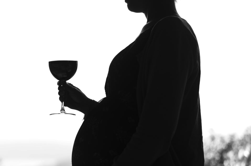 Generic pregnant woman drinking alcohol.