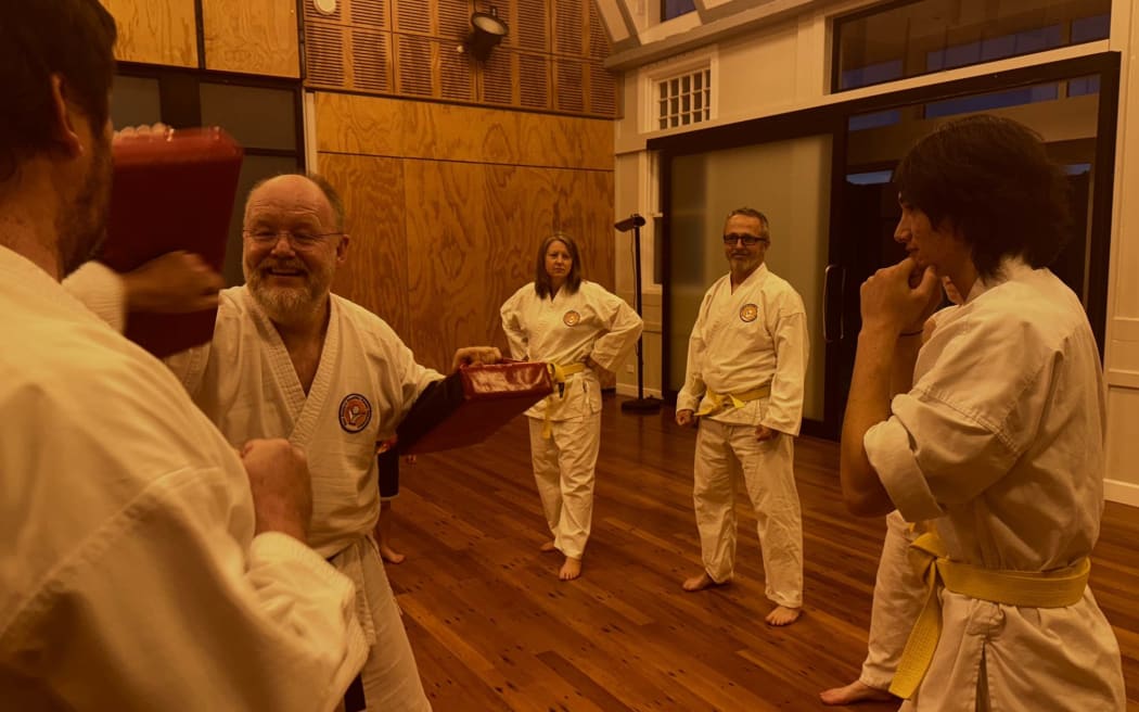 Stephen Hilson, left facing camera, leads a class at NZ Disability Karate Association in Khandallah