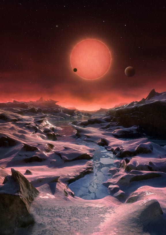 An artist’s impression showing the possible view from the surface one of the three planets orbiting an ultracool dwarf star just 40 light-years from Earth.