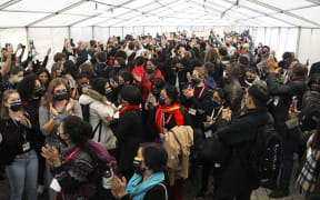 Climate activists and delegates stage a walk out in protest of the ongoing negotiations at the COP26 climate change conference.