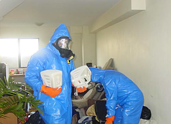 Workers at a contaminated property.
