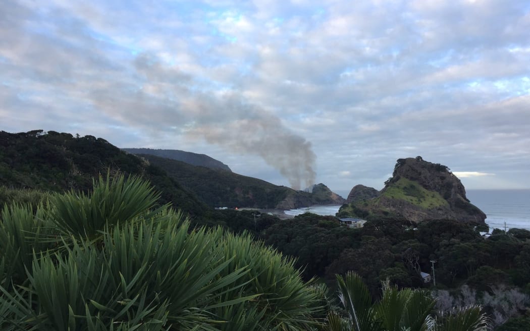 Smoke can be seen from the fire at Piha.