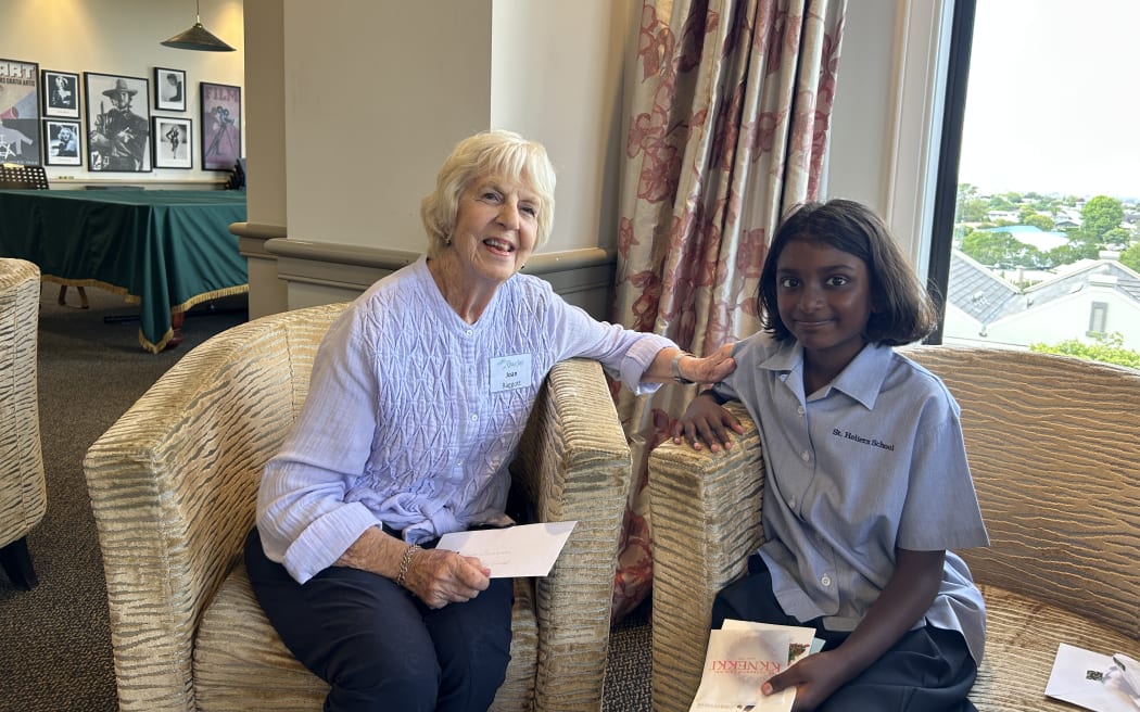 Photo of a retirement home resident and a school girl.