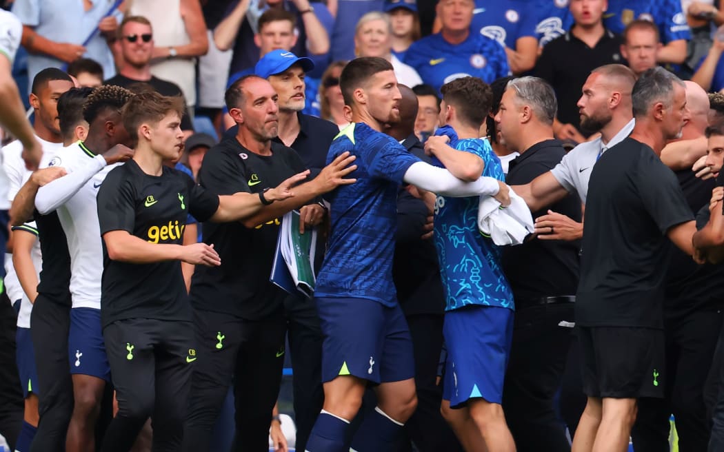 Chelsea Manager Thomas Tuchel is shielded by players as Tottenham Hotspur Manager Antonio Conte is held back from speaking with him, 2022.